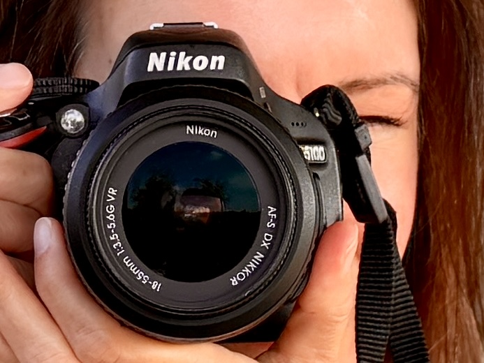 Close up of Lauren holding a camera