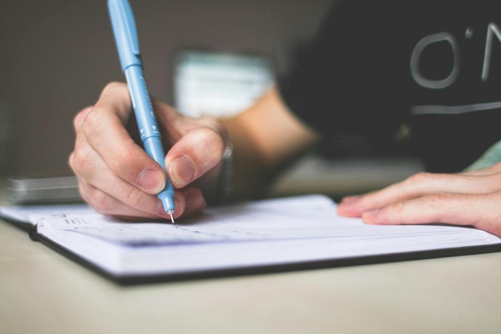 A woman's hand writing in a journal
