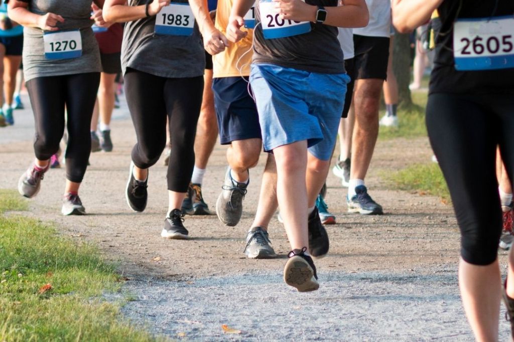 A group of people walking in 5K race