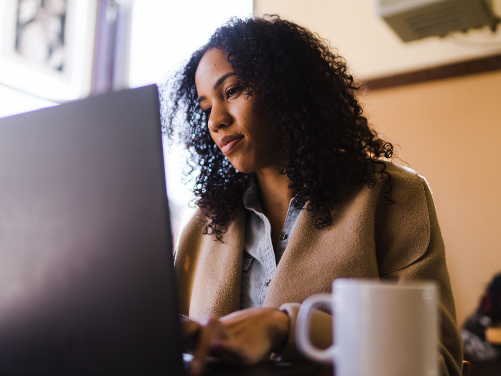 A woman doing work at a computer